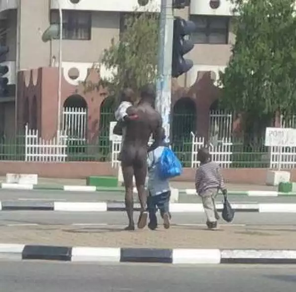God!! N*ked Man Spotted Roaming The Streets Of Abuja With His 3 Kids [See Photo]